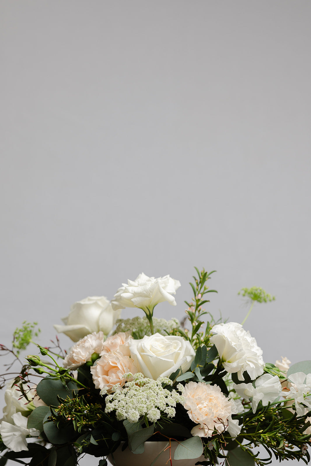 Wedding Centerpiece of white flowers in a footed bowl