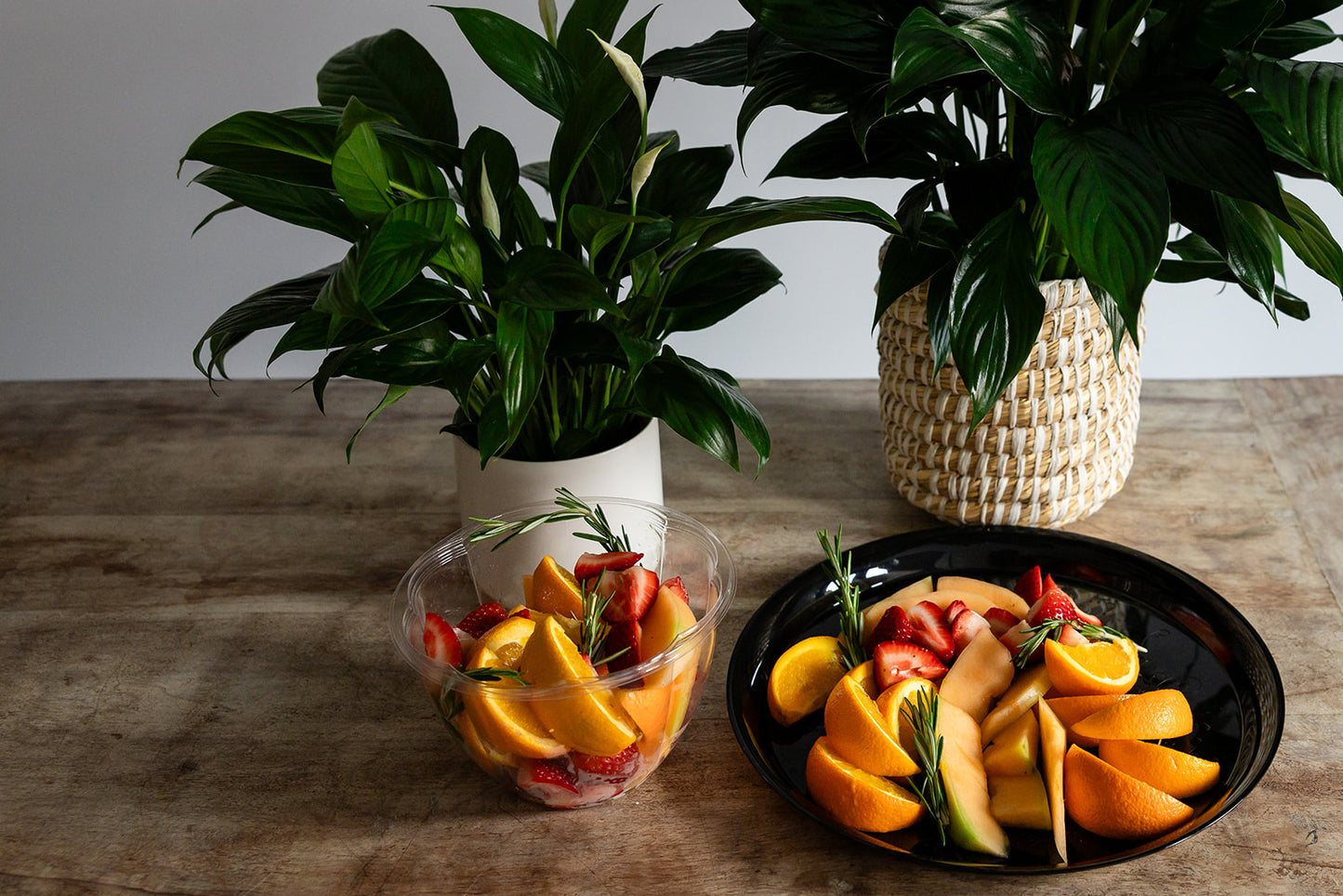 Fruit platter with fresh seasonal fruits and peace lilies