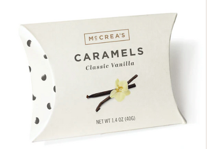 McCrea's Classic Vanilla Caramels packaging with vanilla beans and flower on a white background