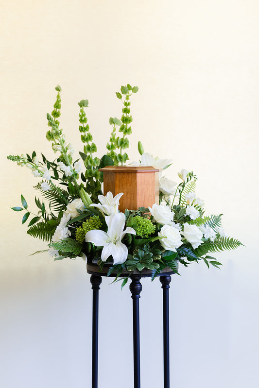 Fresh flowers surrounding a cremation urn