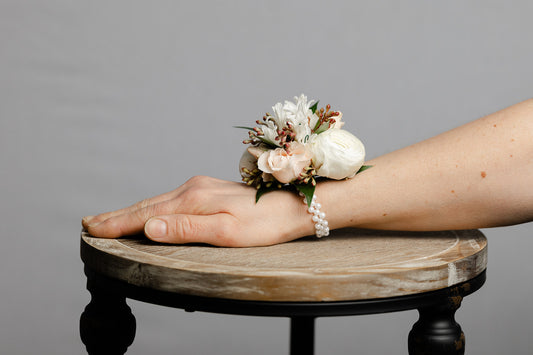 White flower wrist corsage on a wrist